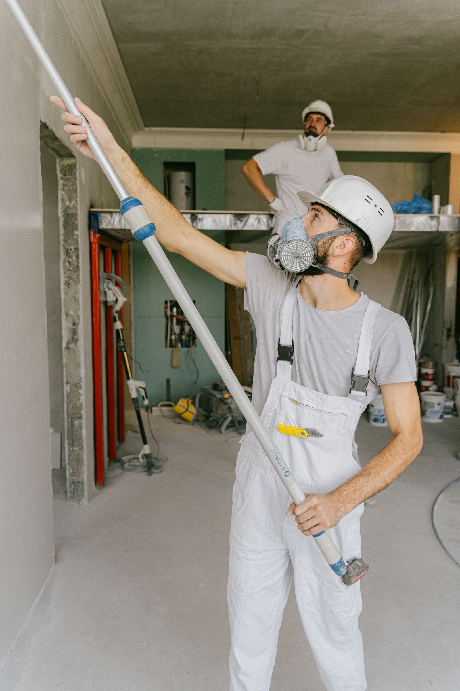Construction crew renovating a commercial interior ceiling